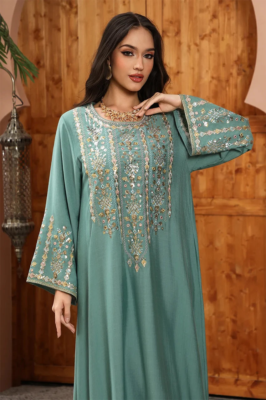 Close-up of the artisan embroidery and light-reflecting sequin details on the Zahia Green Kaftan neckline.