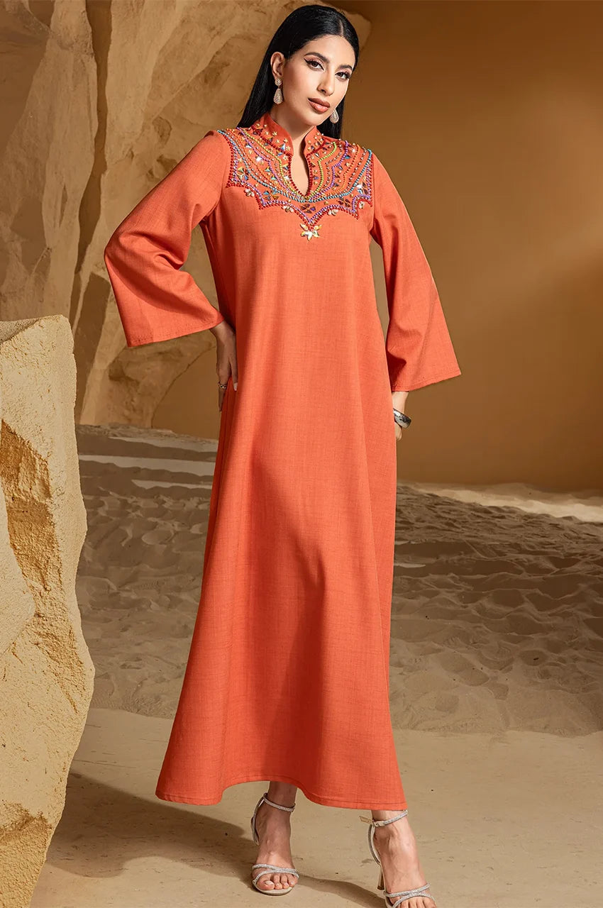 Model wearing Zahra orange kaftan with statement embroidery