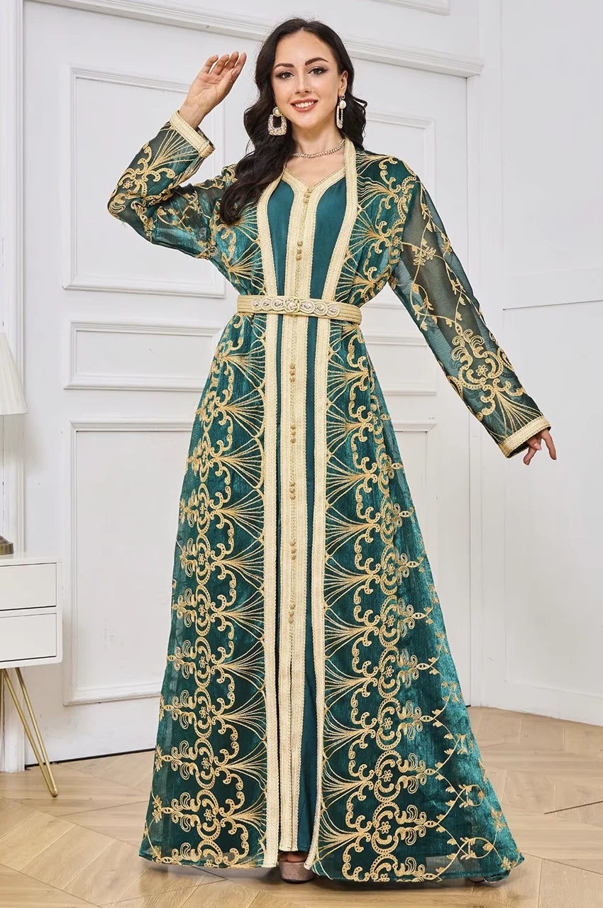 Walking side view showing the flow of the gold embroidered army green kaftan sleeves.
