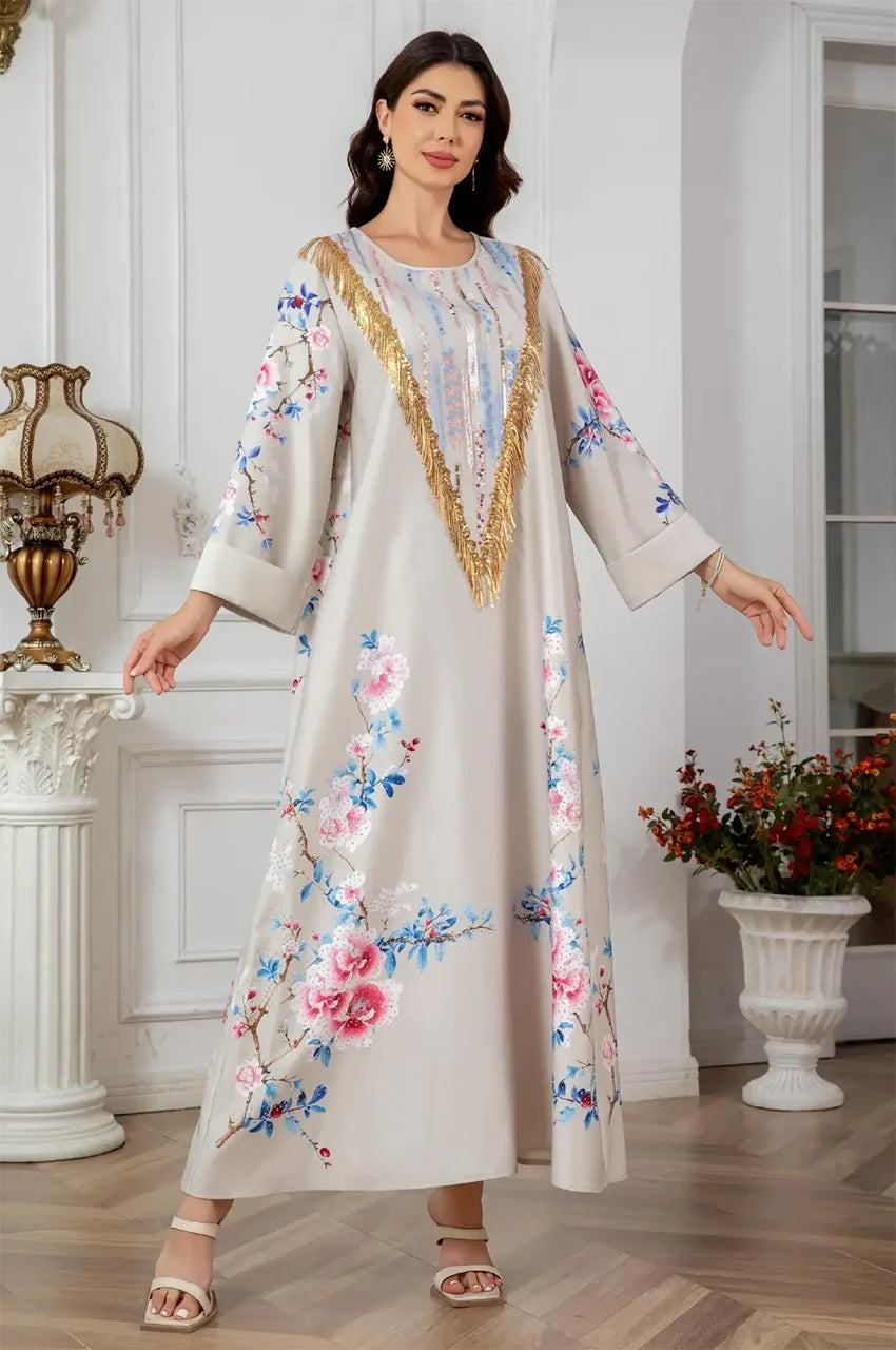 Fashion model posing in Zaree gold sequin kaftan with wide sleeves.