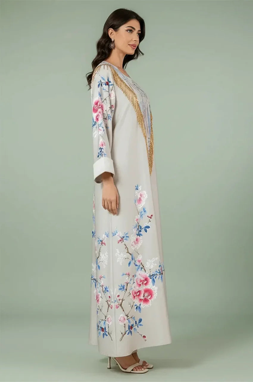 Side profile of Zaree kaftan highlighting the gold fringe drape.