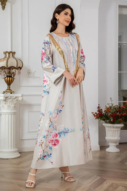 Model standing with hands joined wearing Zaree gold sequin kaftan.