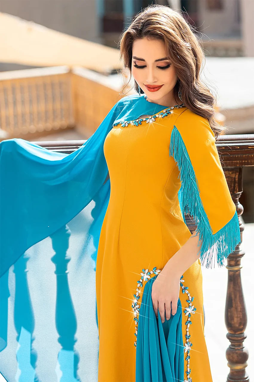 Mid-shot of Zayna kaftan cape focusing on the jeweled trim and asymmetric cape integration.