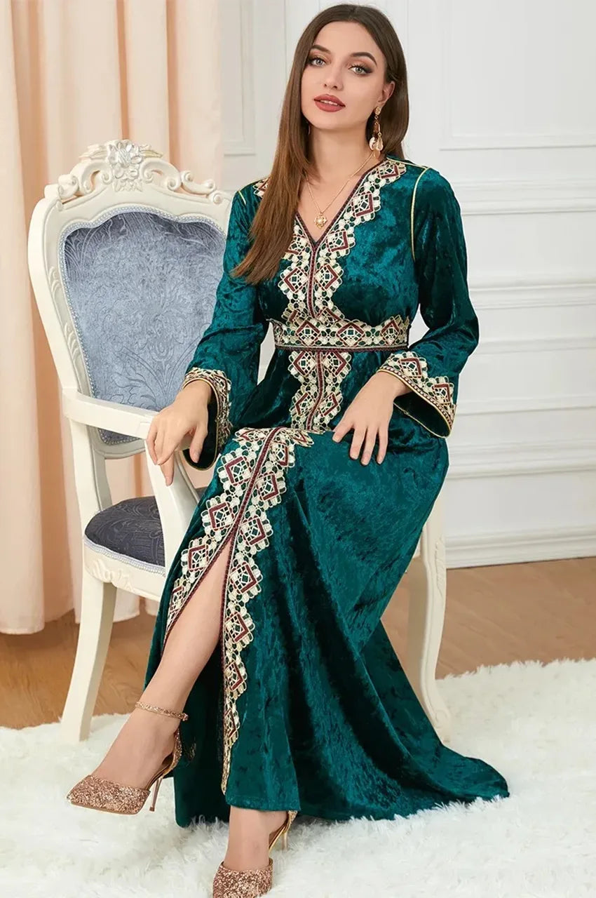 Seated model wearing Zaynah green Moroccan velvet kaftan with traditional embroidery