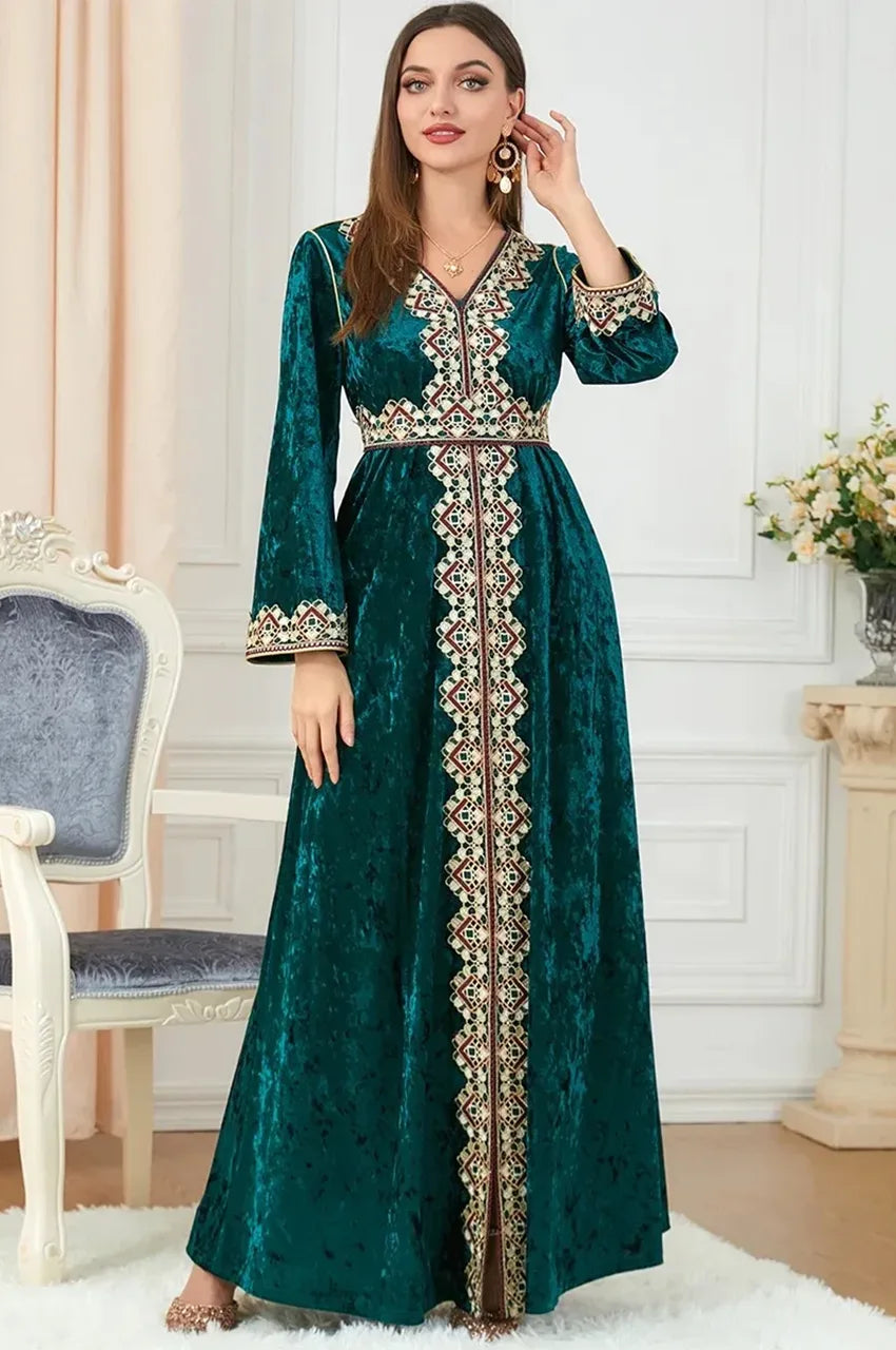 Full-length standing view of Zaynah green Moroccan velvet kaftan with front slit