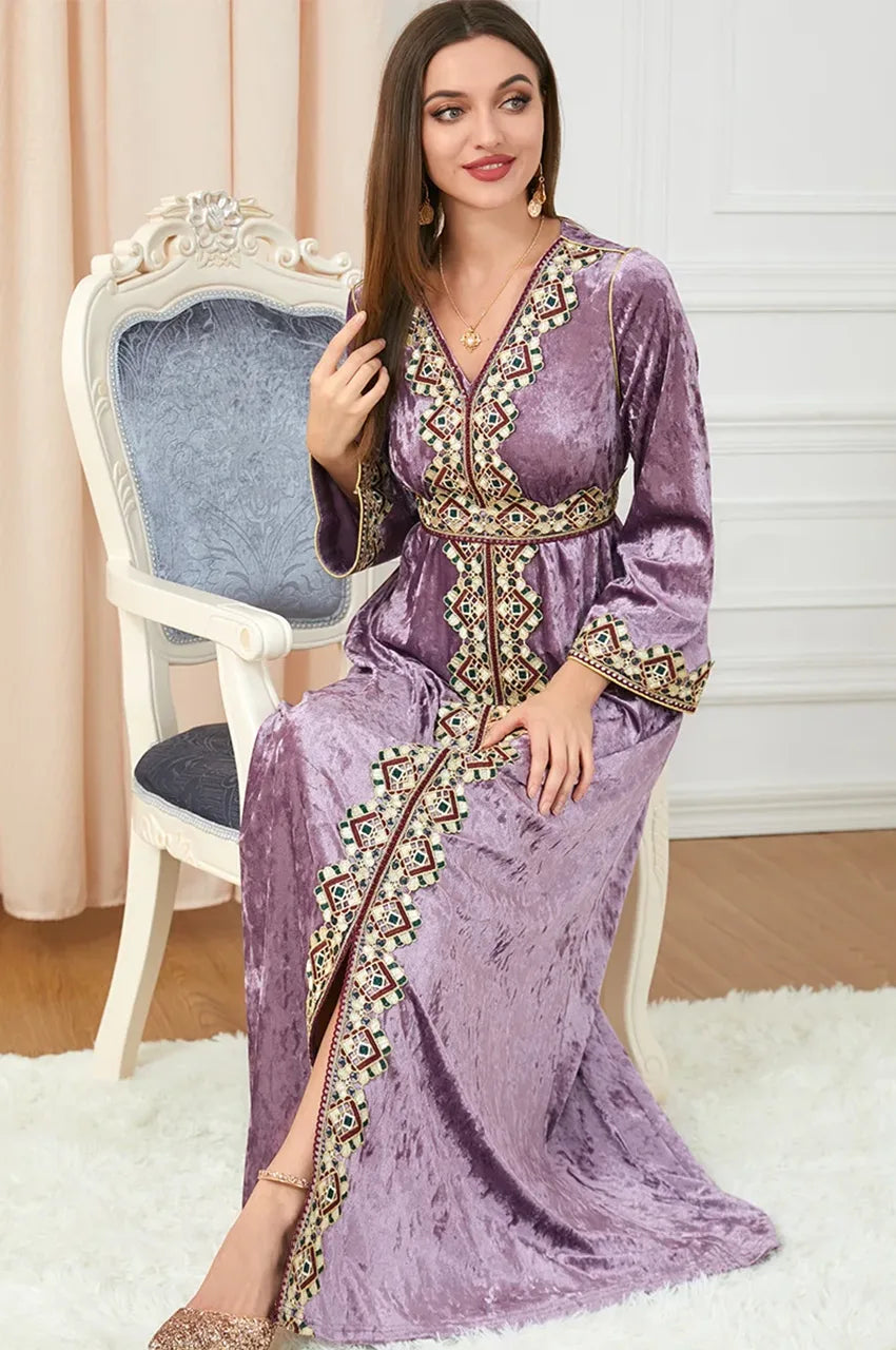 Model seated wearing Zaynah pink Moroccan velvet kaftan with Moroccan embroidery