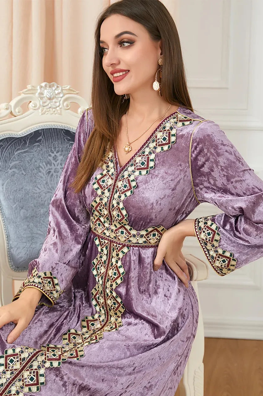 Close-up seated view of Zaynah pink Moroccan velvet kaftan with detailed trim