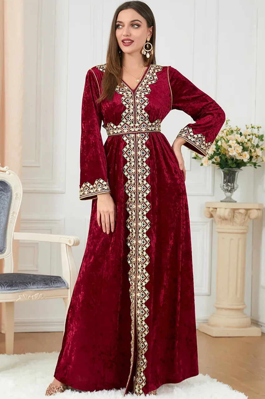 Full-length standing view of Zaynah red Moroccan velvet kaftan with detailed trim