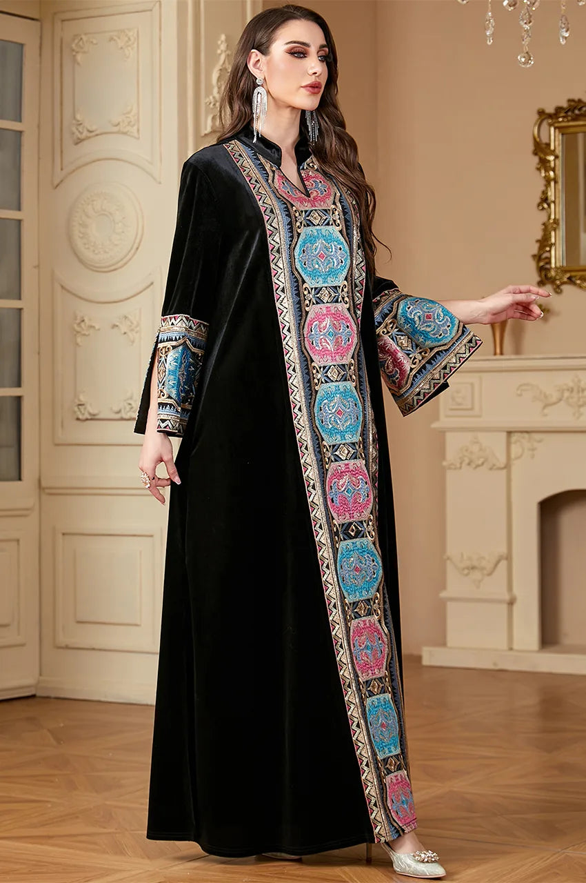 Model posing in Zeina black velvet kaftan showing A-line silhouette.