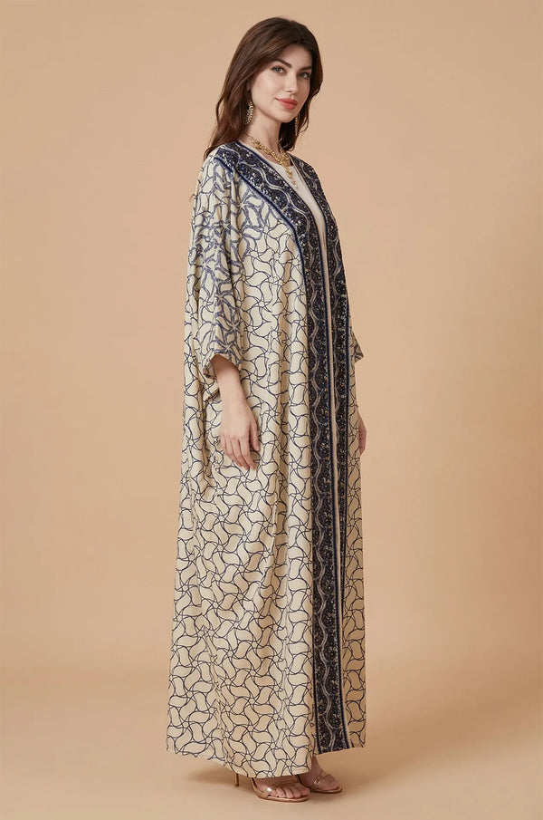 Side profile of the Zelia ivory kaftan highlighting the fluid fabric drape.